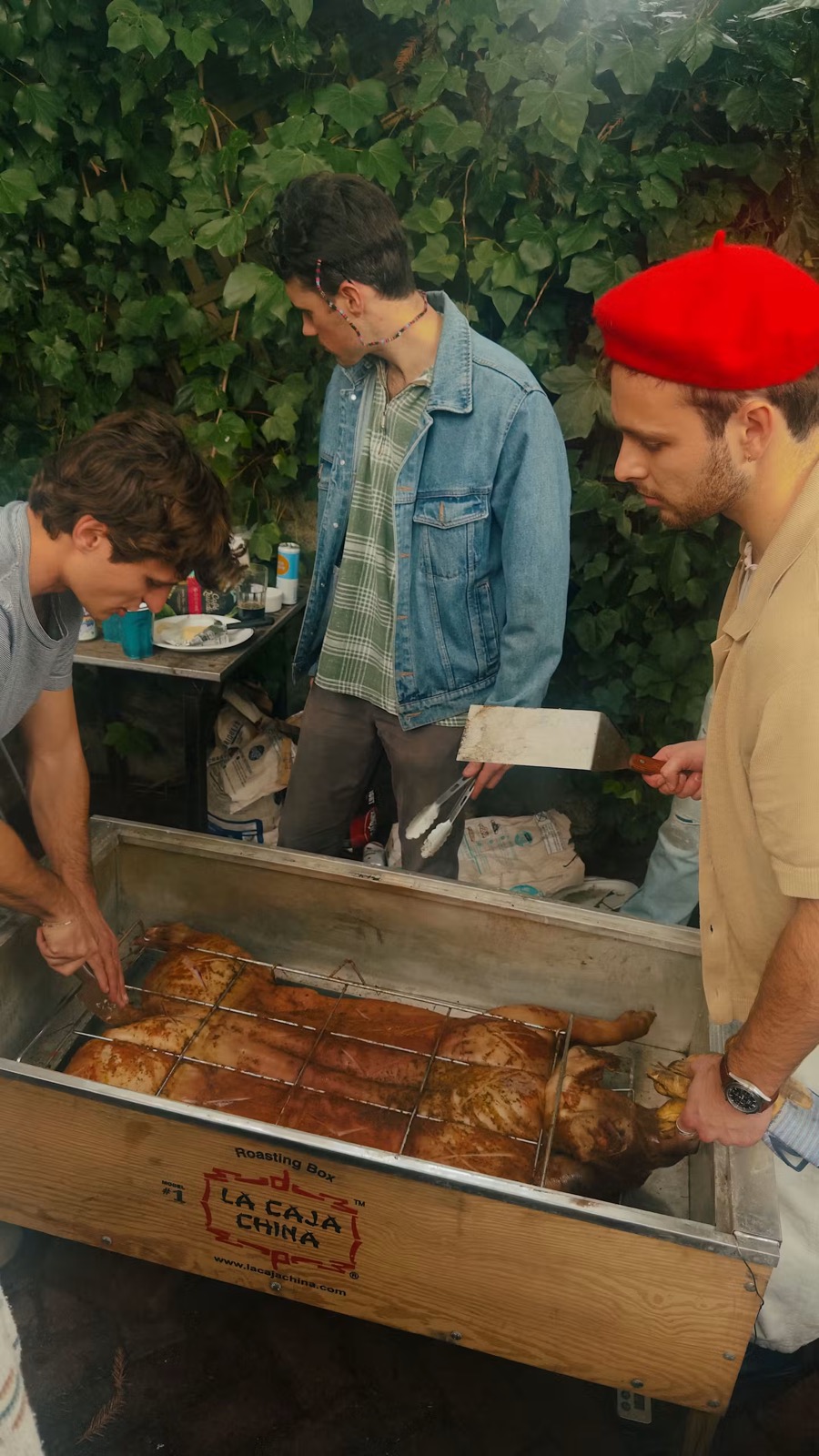 Roasting a whole pig in a Caja China with friends